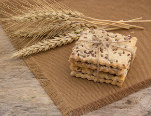 Fresh crispy cereal cookies and ears on rustic wooden table