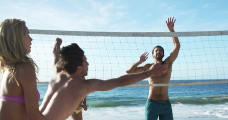 Friends playing beach volleyball