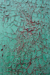 Green oil paint was peeling on the red metal as the streaks of b