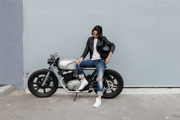 Plakat Biker woman in leather jacket on motorcycle