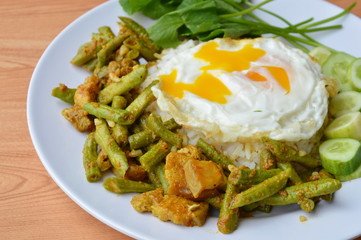 spicy stir fried yard long bean with fat pork curry and creamy egg yolk on rice