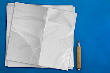 Top view of paper note with pencil on blue table