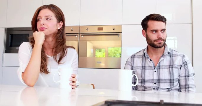 Couple not talking after an argument in kitchen