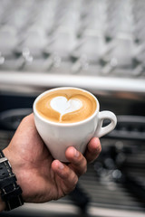Coffee art. A latte coffee art in barista hand