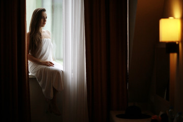 Fototapeta premium glamor portrait of a girl hotel window