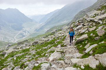 Fototapeta na wymiar Woman backpacker hiking on a trail