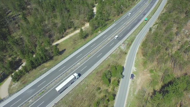 AERIAL: Trucks and cars driving on a freeway