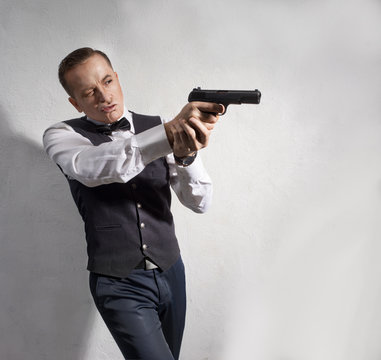 elegant man with a gun