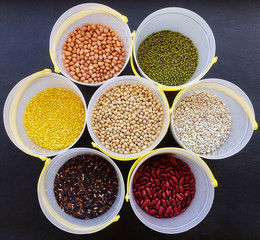 Mixed beans and lentils of different legumes on black background 