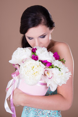 woman smelling big bouquet of summer flowers