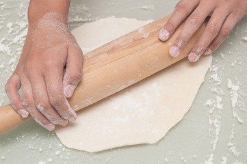 Female hand preparing dough