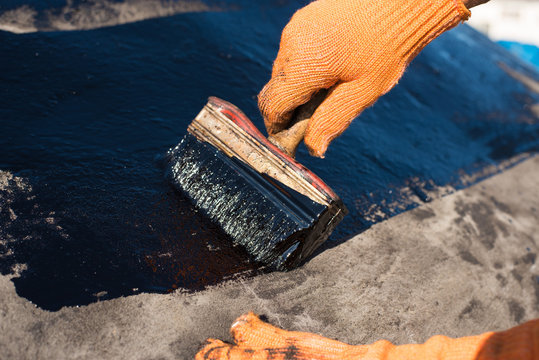 worker making waterproofing.