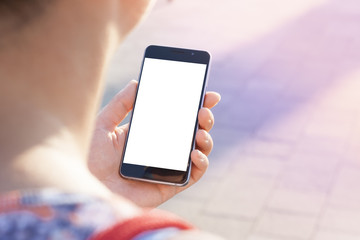 Woman hand holding contemporary modern smartphone. Visual effects. Blank display replaceable with needed design.Vertical mockup