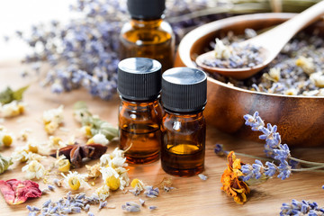 essential oils with dried herbs - obrazy, fototapety, plakaty