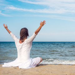 Woman meditating at the sea