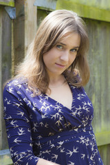 Fototapeta premium Long-haired young woman in dress outdoors