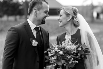 Bride and groom look awesome smiling on the field