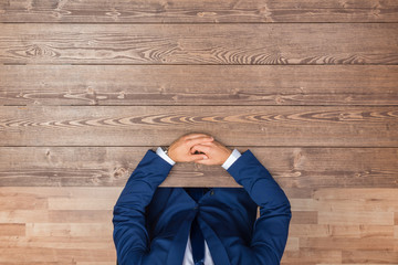 Overhead shot of businessman in the dark suit sitting at the table