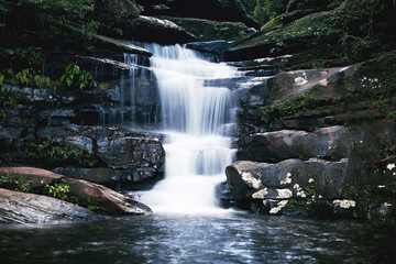 Fototapeta na wymiar beautiful waterfall with dark toned, vignette corner