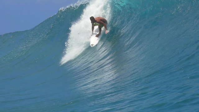 SLOW MOTION: Extreme surfer surfing inside big tube barrel wave