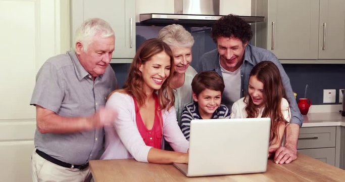 Happy family using laptop together