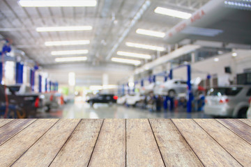 Wood table top with blur garage background