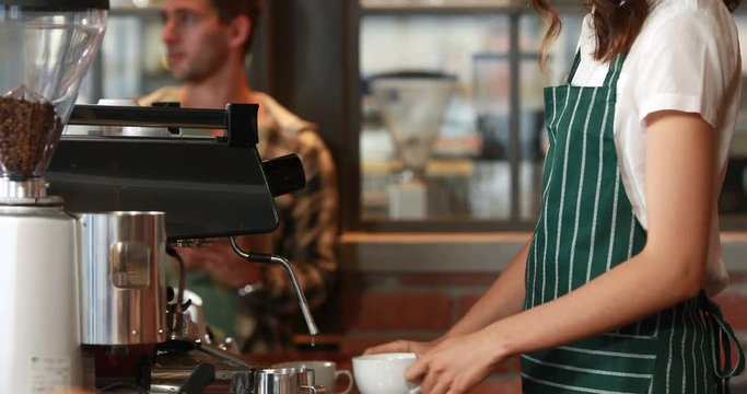 Smiling barista serving a client