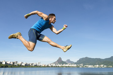 Athlete in blue sport uniform jumping above the Rio de Janeiro, Brazil skyline at Lagoa Rodrigo de...