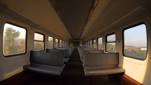 The train is moving to a destination. View inside the empty carriage