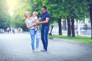 Happy family having weekend in summer park