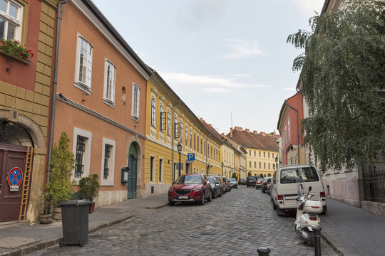 Fototapeta Old narrow street with parked cars in Budapest, Hungary.