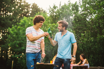 Obraz premium Men making barbecue together