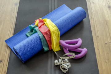 Home fitness accessories on yoga mat
