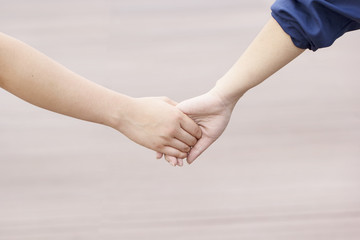 Close-up Holding Hands of two girl, friendship and relationship