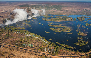 Fototapeta na wymiar View of the Falls from a height of bird flight. Victoria Falls. Mosi-oa-Tunya National park.Zambiya. and World Heritage Site. Zimbabwe. An excellent illustration.