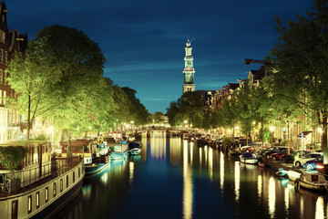 Naklejka premium Westerkerk church tower at canal in Amsterdam, Netherlands