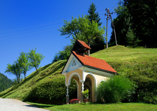 Boharina, under Rogla hill, Pohorje mountains, Slovenia, Europe - picturesque scenery of small christian catholic chapel in beautiful Slovenian nature. Spring / summer sunny time. 
