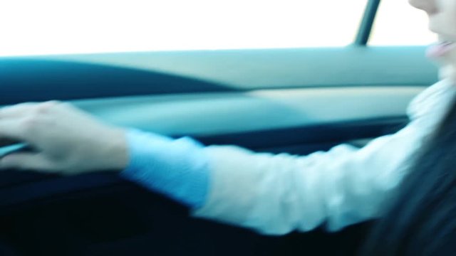young frightened girl sits in locked car - she can't open the door - powerless