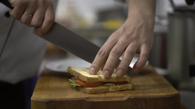 Chef preparing sandwich in the restaurant's kitchen. Close up