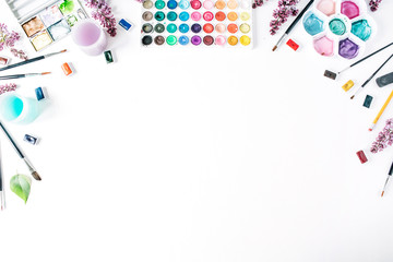 Obraz premium Watercolor and brushes at white background. Flat lay, top view