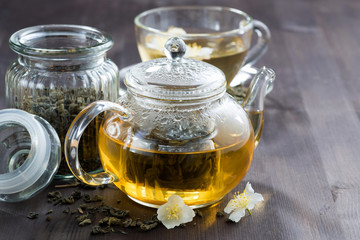 green tea with jasmin on wooden background