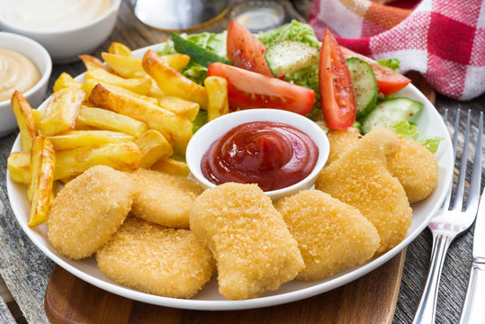 lunch with chicken nuggets, french fries, salad