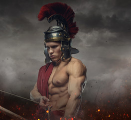 Muscular male in spartan costume holding wooden bow.