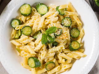 Pennette pasta with courgettes, mint leaves and parmesan