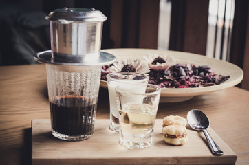 Fresh coffee with milk, syrup candy on a wooden table. Selective