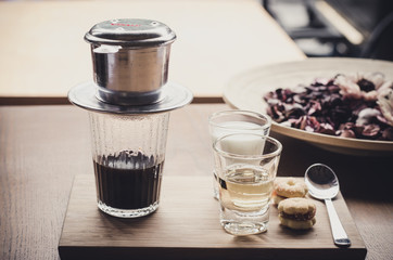 Fresh coffee with milk, syrup candy on a wooden table. Selective