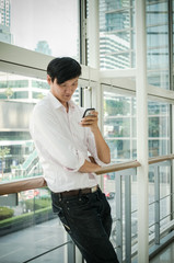 Fototapeta premium asian man. businessman talking on mobile phone in modern office
