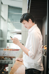 asian man. businessman looking on mobile phone in modern office