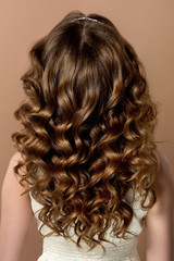 Fototapeta premium Fashion portrait of young woman with magnificent curly hair. Per