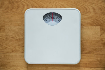 Diet bathroom weight foot scale on old wood background